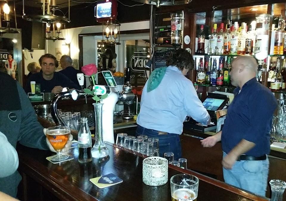 Gasten en personeel aan de bar van De Avonden